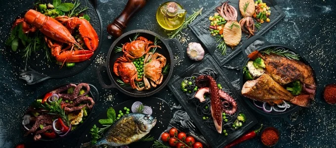 Assorted seafood dishes on slate platters
