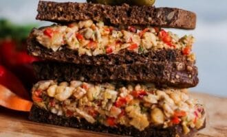 A vibrant chickpea salad sandwich with diced red peppers
