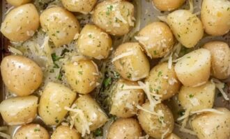 Baby potatoes arranged in a single layer on a baking tray