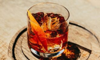 Irish Old Fashioned cocktail served over ice with an orange twist