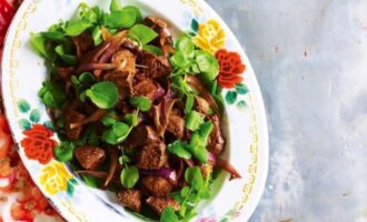 Vietnamese diced beef stir fry with vegetables and herbs